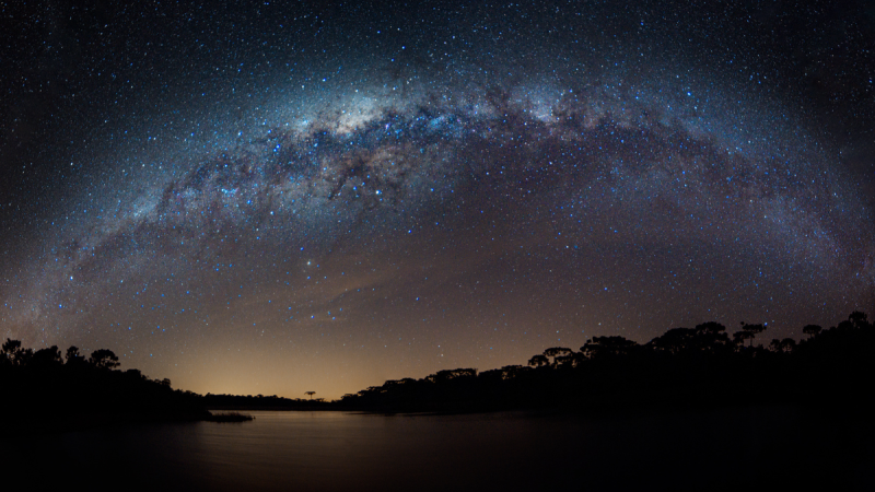 lake under starry night sky