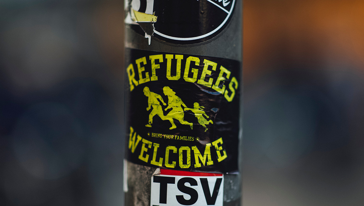 sticker says "refugees welcome"