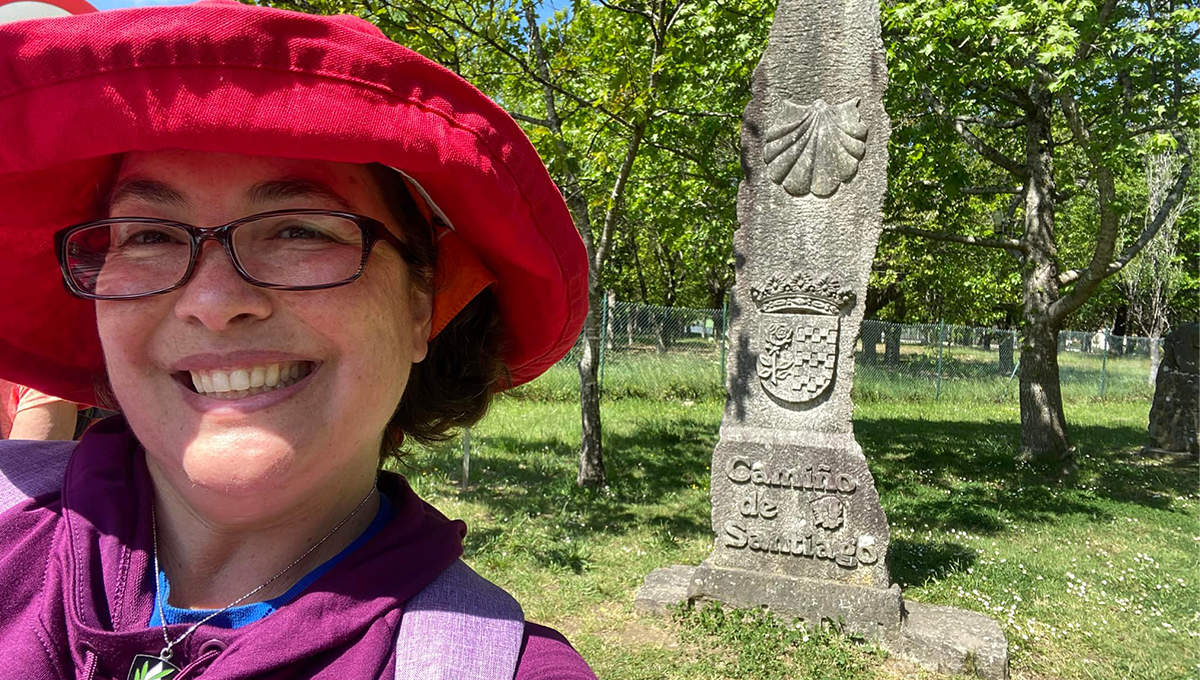 Sister Ana Gonzalez next to a marker on the Camino de Santiago