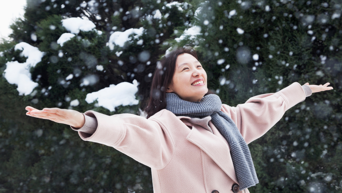 woman enjoys the wonder of snowfall