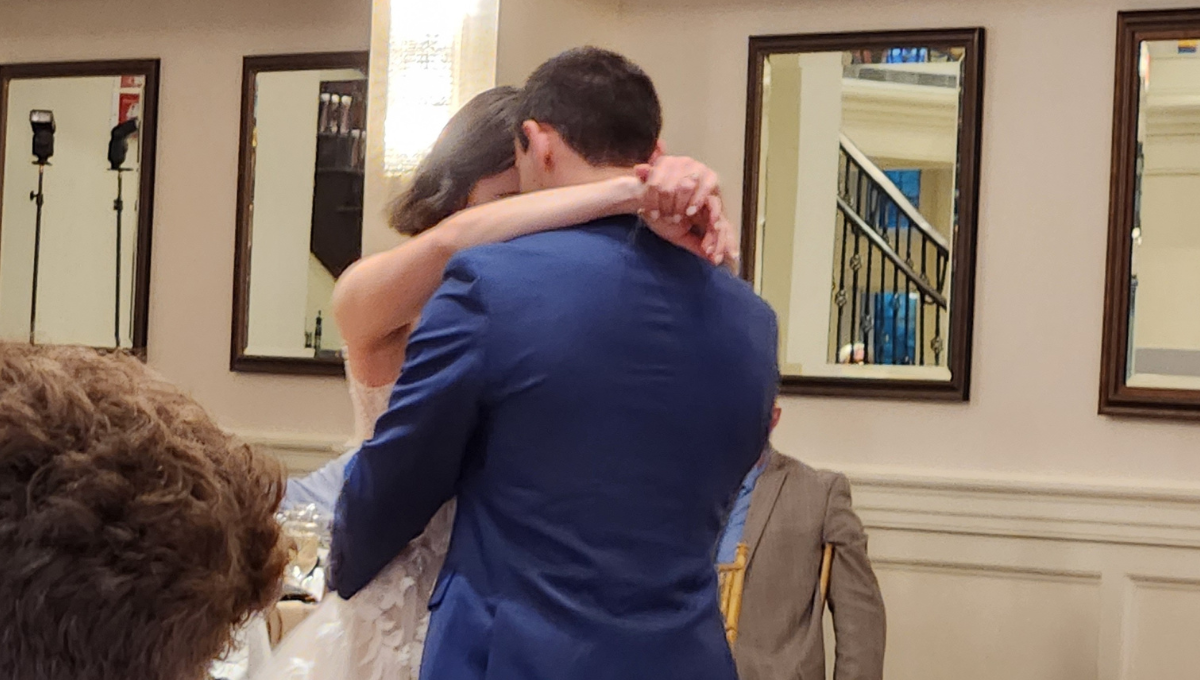 A bride and groom embrace 