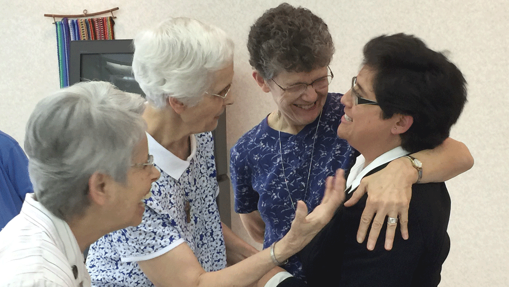 Sisters greet each other after the podcast.