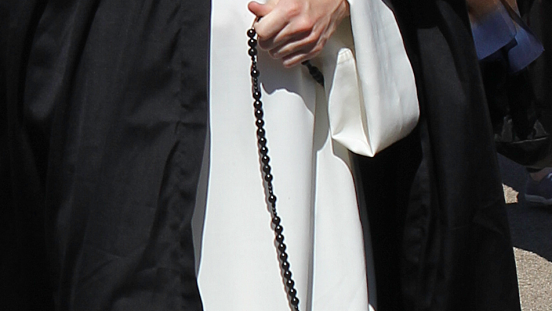 hand holding habit rosary