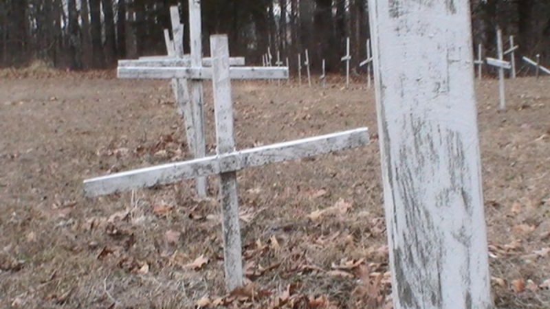 unlabeled white wooden crosses mark the anonymous graves of slaves