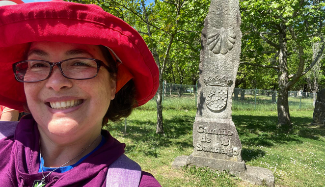 Sister Ana Gonzalez next to a marker on the Camino de Santiago